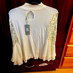 Butterfly sleeved white top.